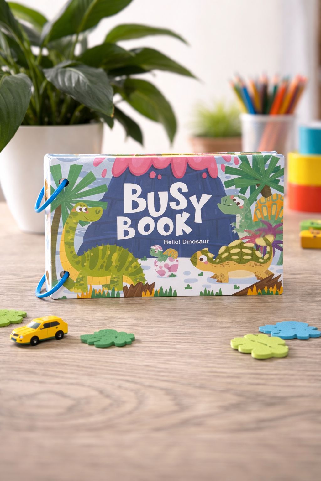 Busy book with dinosaur theme on a wooden table